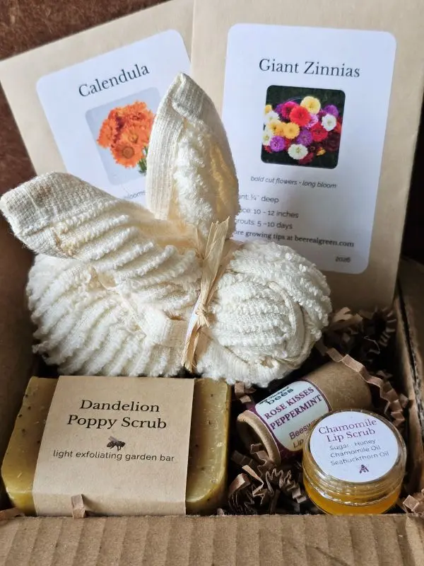 Close-up of Spring Pollinator Basket showing cotton washcloth bunny, pollinator seed packets, and botanical scrub soap.