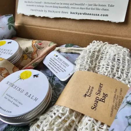 close-up of new mom gift box with natural self-care products and botanical packaging