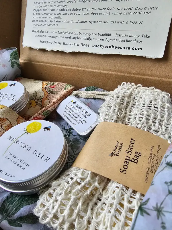 close-up of new mom gift box with natural self-care products and botanical packaging