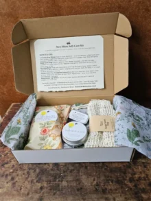 Backyard Bees new mom gift box with handmade self-care items including eye pillow, nursing balm, lip balm, herbal salve, and soap saver