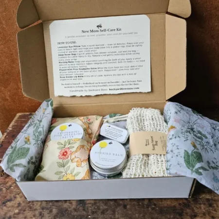 Backyard Bees new mom gift box with handmade self-care items including eye pillow, nursing balm, lip balm, herbal salve, and soap saver