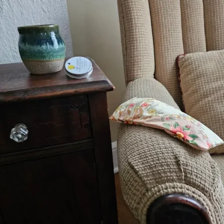 lavender eye pillow resting on chair as part of new mom self-care gift set