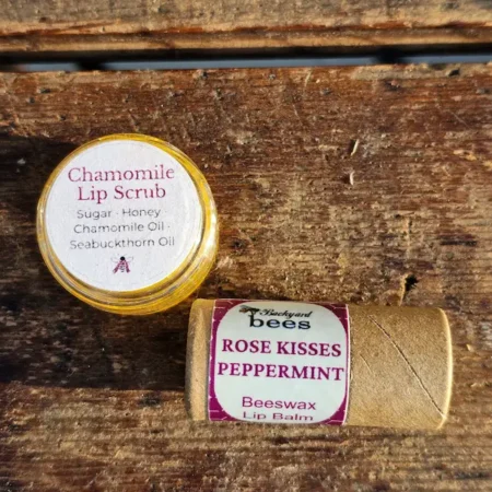 Honey chamomile lip scrub and peppermint lip balm on a wooden surface