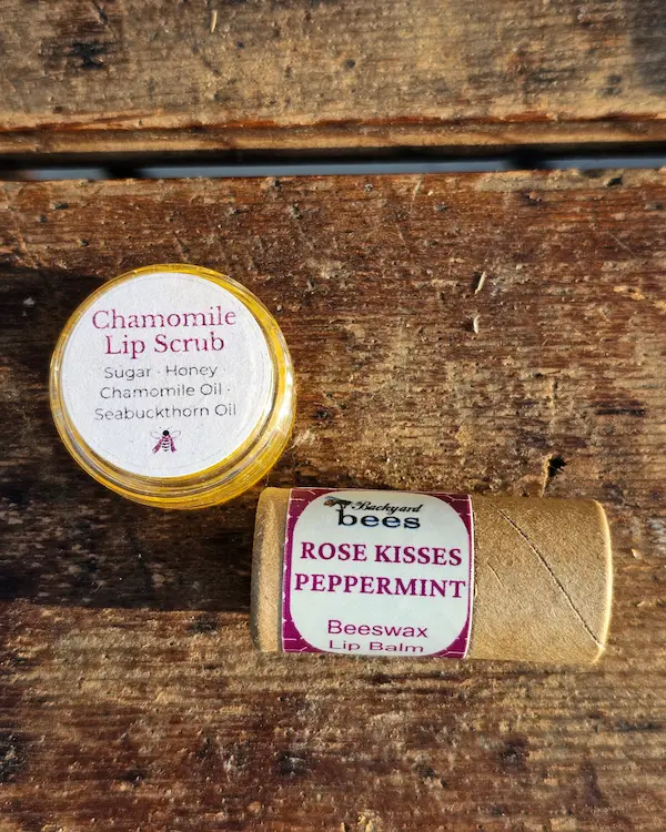 Honey chamomile lip scrub and peppermint lip balm on a wooden surface