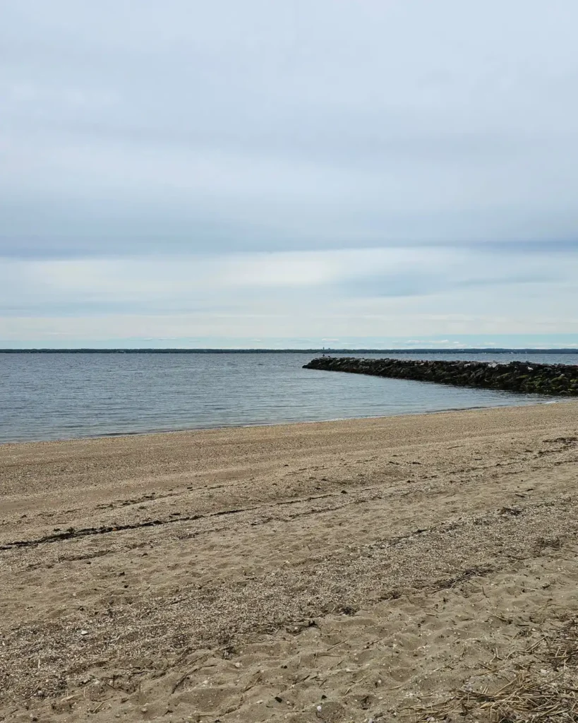 Sandy beach and calm waters of the Long Island Sound at Welwyn Preserve
