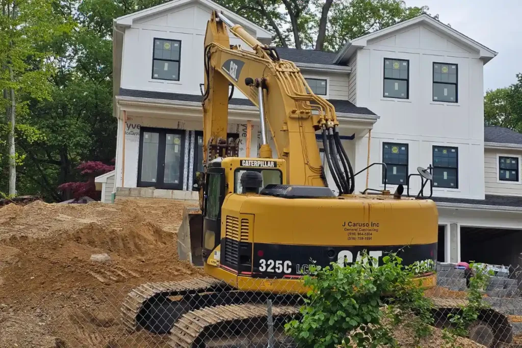 backhoe and compacted dirt on new home build site