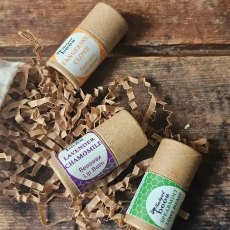 Bee Kissable Lip Balm Trio Closeup Close up of three flavors of beeswax lip balms by Backyard Bees