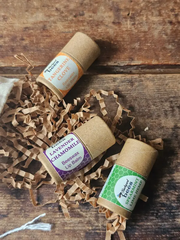Bee Kissable Lip Balm Trio Closeup Close up of three flavors of beeswax lip balms by Backyard Bees