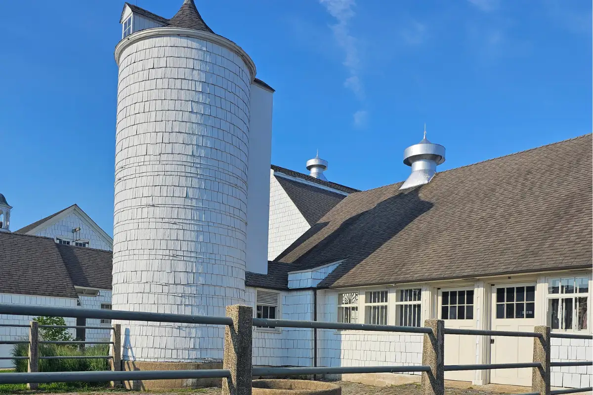 The Walled Garden At Caumsett State Park 1 Restored dairy barns and silo at Caumsett State Park beneath a bright blue summer sky.