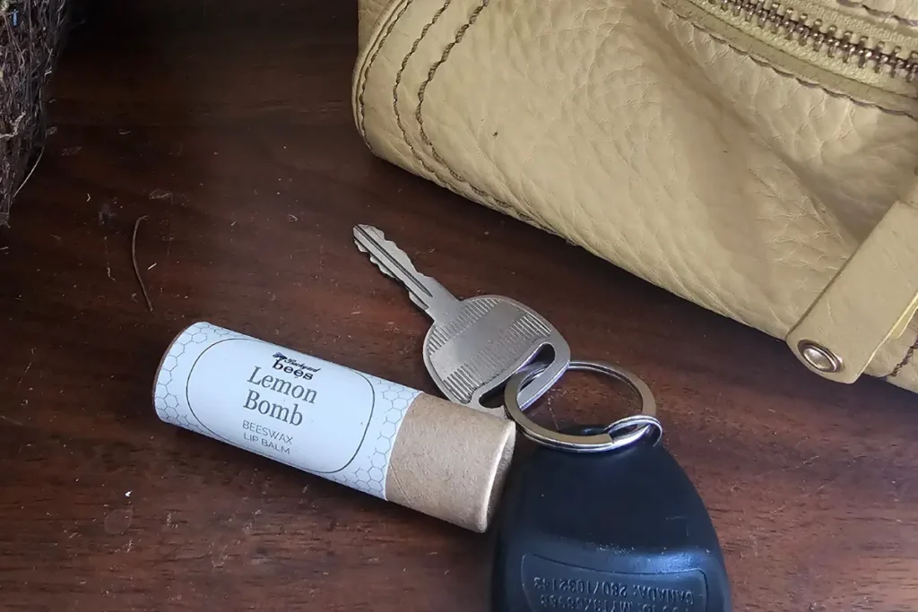 Lemon Bomb lip balm tucked into a purse for everyday use