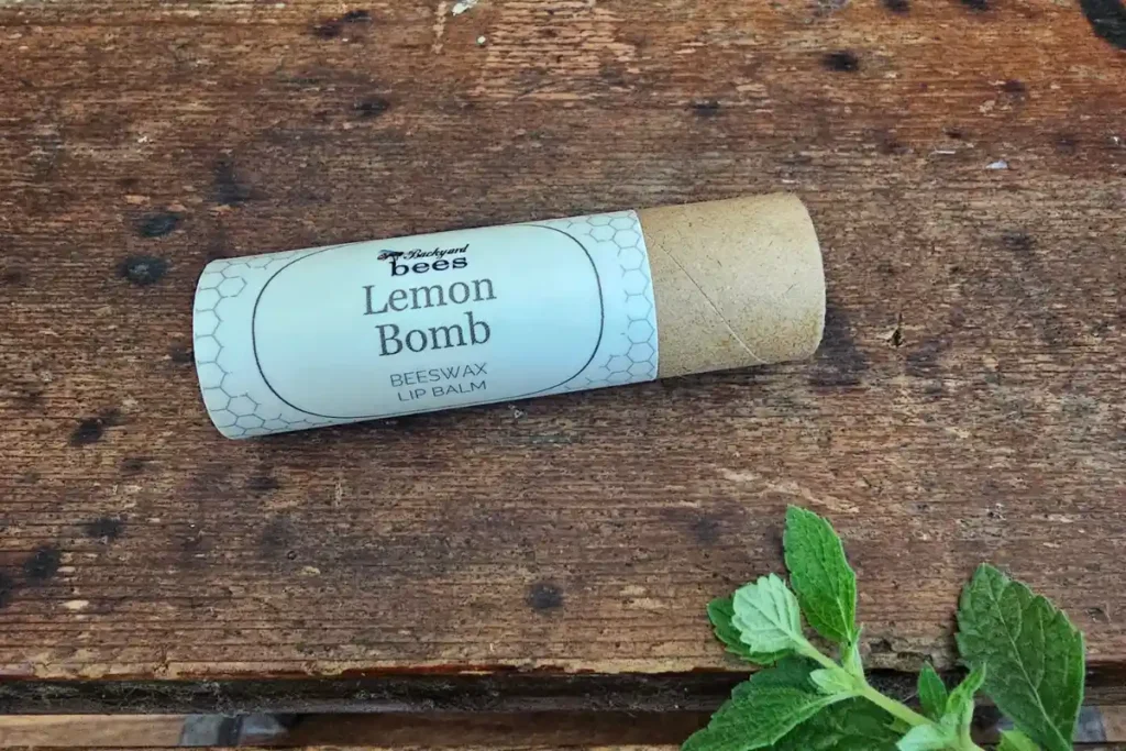 The Hive 10 Lemon Bomb lip balm by Backyard Bees in a compostable paper tube