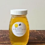 half-pound jar of Roslyn local honey on wooden table