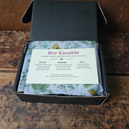 Open Bee Kissable gift box showing botanical tissue paper and skincare ritual insert